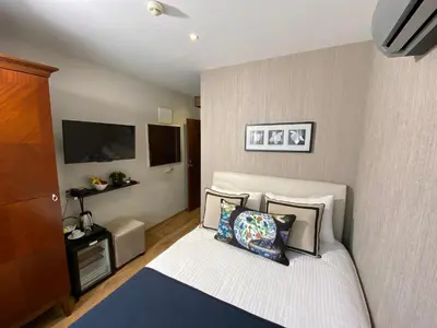 a bedroom with a bed with pillows and a tv at Four Doors Hotel in Istanbul