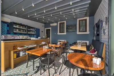 a restaurant with wooden tables and chairs and a counter at Four Doors Hotel in Istanbul