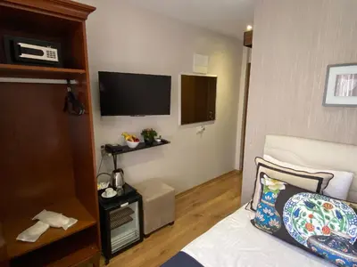 a hotel room with a bed and a flat screen tv at Four Doors Hotel in Istanbul
