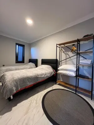 a bedroom with two beds and a rug at Loft Sabırlı in Kaynarca