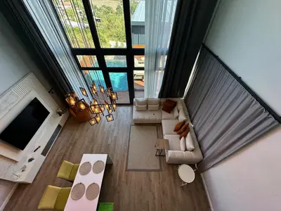 an overhead view of a living room with a large window at Loft Sabırlı in Kaynarca
