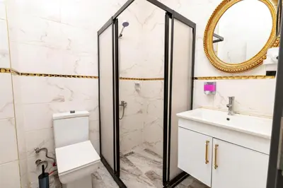 a bathroom with a shower and a toilet and a sink at Highway 34 Hotel in Istanbul