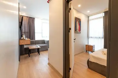 a bedroom with a bed and a living room with a couch at Highway 34 Hotel in Istanbul