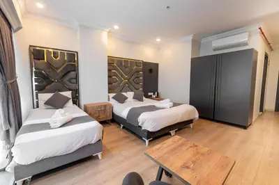 a hotel room with two beds and a table at Highway 34 Hotel in Istanbul
