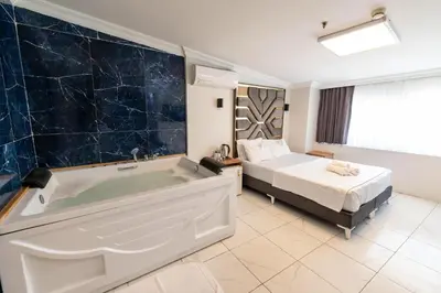 a bathroom with a bed and a tub in a room at Highway 34 Hotel in Istanbul