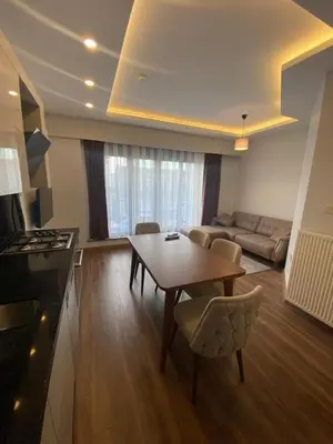 a living room with a table and a couch at Şişli Merkezde Konforlu Daire in Istanbul