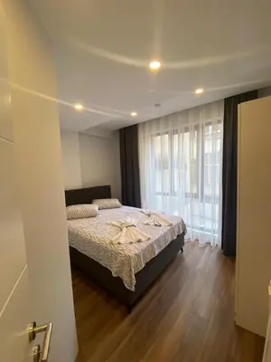 a bedroom with a bed and a large window at Şişli Merkezde Konforlu Daire in Istanbul