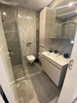a bathroom with a shower and a toilet and a sink at Şişli Merkezde Konforlu Daire in Istanbul