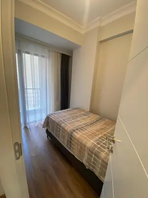 a bedroom with a bed in a room with a window at Şişli Merkezde Konforlu Daire in Istanbul