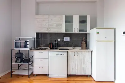 a kitchen with white cabinets and a white refrigerator at Historic 4BR 4BA Mansion Seaview Yedikule Old Town in Istanbul