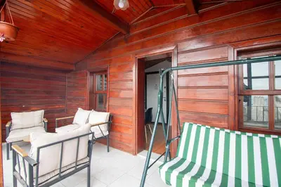 a porch with two white chairs and a window at Historic 4BR 4BA Mansion Seaview Yedikule Old Town in Istanbul
