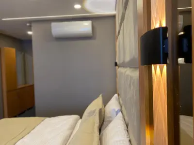 a bedroom with a bed and a wall with a door at Tuyap Vip inn Hotels in Istanbul