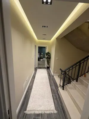 a hallway of a home with stairs and a rug at Luxury Villa with Private Pool Garden Lake View in Sapanca in Sapanca