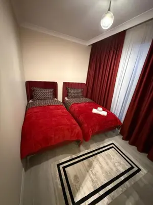 a bedroom with two beds with red covers and a window at Luxury Villa with Private Pool Garden Lake View in Sapanca in Sapanca