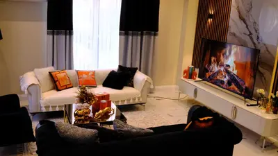 a living room with two couches and a flat screen tv at Luxury Villa with Private Pool Garden Lake View in Sapanca in Sapanca