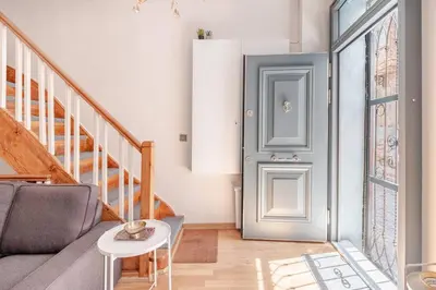 a living room with a gray couch and a door at Private House Istanbul City in Istanbul