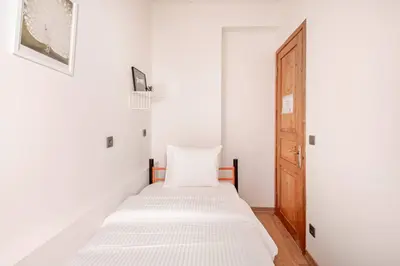 a white bedroom with a bed and a door at Private House Istanbul City in Istanbul