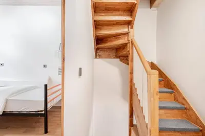 a staircase in a room with white walls and wooden ceilings at Private House Istanbul City in Istanbul
