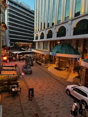 a city street with cars parked in front of buildings at Taksim Flat Apartment in Istanbul