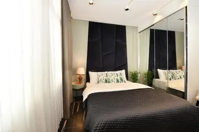 a bedroom with a large bed and a mirror at Taksim Flat Apartment in Istanbul