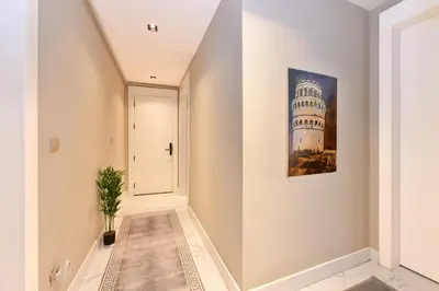 a hallway with a painting of the leaning tower at Taksim Flat Apartment in Istanbul
