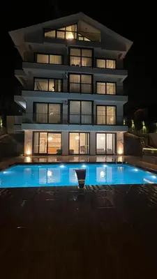 a building with a swimming pool in front of it at night at 4 Mevsim Konak in Kartepe