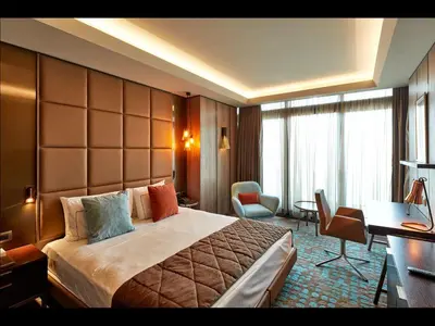 a hotel room with a large bed and a desk at Naz City Hotel Taksim - Special Category in Istanbul