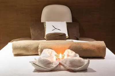 a bedroom with a bed with a candle and a chair at Naz City Hotel Taksim - Special Category in Istanbul