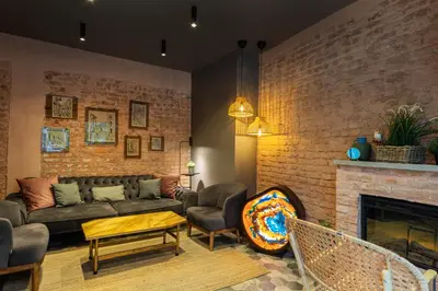 a living room with a couch and a brick wall at Ayramin Deluxe Hotel Taksim in Istanbul