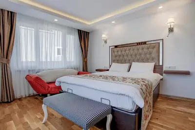 a hotel room with a large bed and a chair at Violin Hotel Sultanahmet in Istanbul