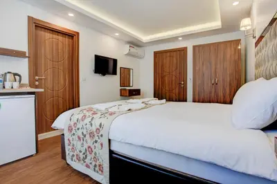 a bedroom with a large white bed and wooden cabinets at Violin Hotel Sultanahmet in Istanbul