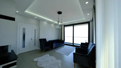 a living room with two chairs and a rug at 4 Mevsim Konak in Kartepe