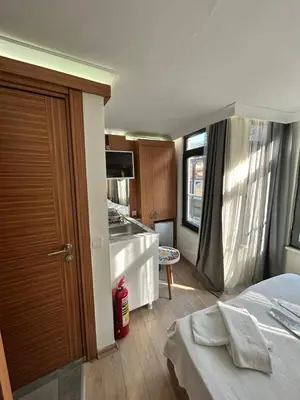 a room with a kitchen and a bed in a room at Viva Sirkeci Butik Hotel in Istanbul