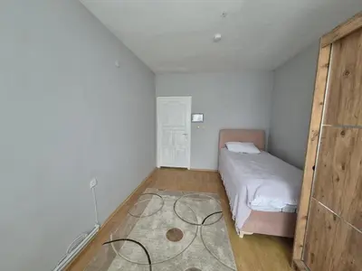 a small bedroom with a bed and a wooden floor at Bosphorus view apartment Sarıyer in Sarıyer