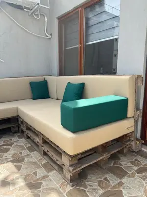 a tan couch with blue pillows in a room at K&Y Taksim Rooftop in Istanbul