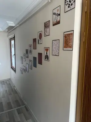 a white wall with many pictures on it at K&Y Taksim Rooftop in Istanbul