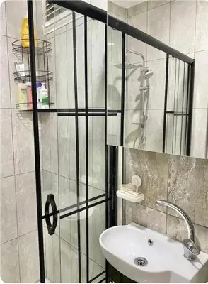 a bathroom with a white sink and a shower at K&Y Taksim Rooftop in Istanbul
