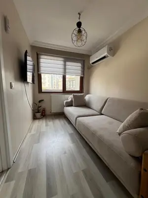 a living room with a couch and wooden floors at K&Y Taksim Rooftop in Istanbul