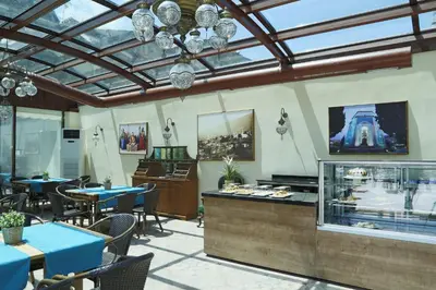 a restaurant with tables and chairs and a chandelier at Bursa İpekyolu Hotel in Bursa