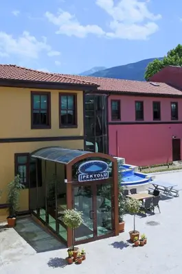a hotel with a sign in front of a building at Bursa İpekyolu Hotel in Bursa