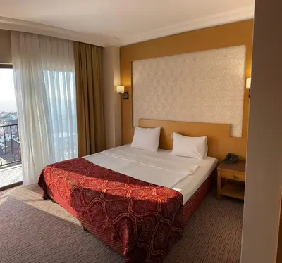 a hotel room with a bed and a large window at Mekanhan Hotel in Gebze