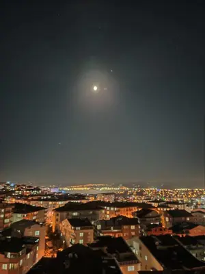 a view of a city at night with the moon at Mekanhan Hotel in Gebze