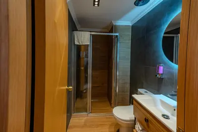 a bathroom with a toilet and a sink at Mekanhan Hotel in Gebze