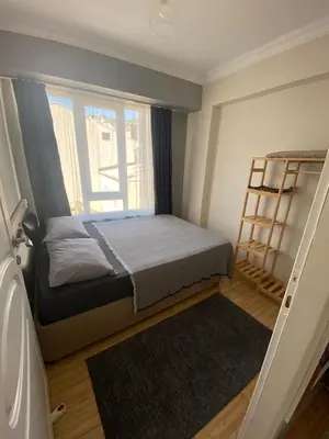 a small bedroom with a bed and a window at Sidelya in Ocaklar