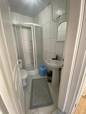 a bathroom with a shower and a toilet and a sink at Sidelya in Ocaklar