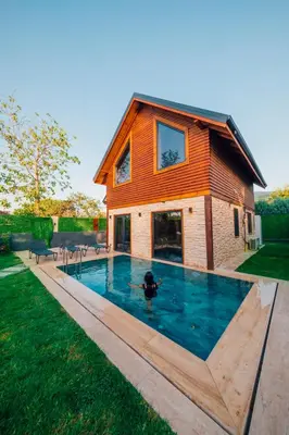 a house with a dog in a swimming pool at Vadi Resort in Korfez