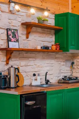 a kitchen with green cabinets and a stove at Vadi Resort in Korfez
