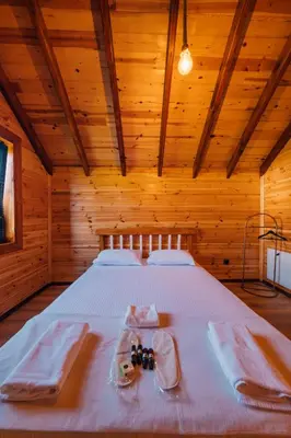 a bedroom with a bed in a wooden room at Vadi Resort in Korfez