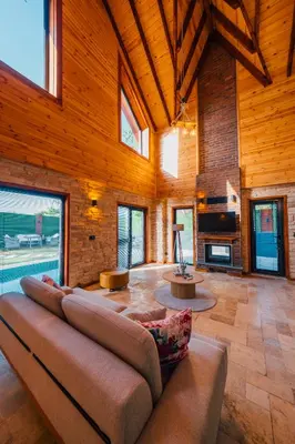a large living room with a couch and a fireplace at Vadi Resort in Korfez