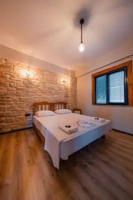 a bedroom with a large bed in a brick wall at Vadi Resort in Korfez